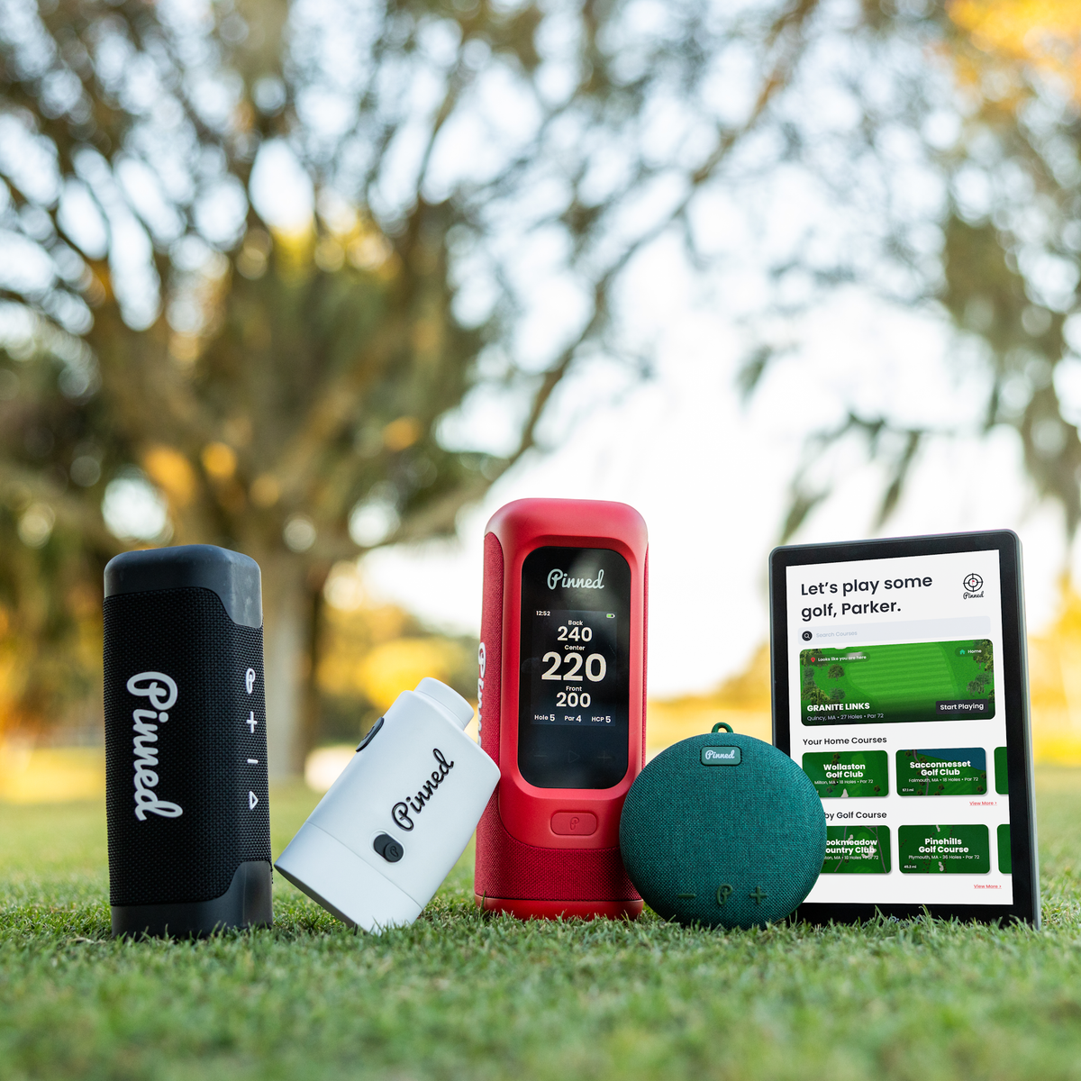 Assortment of all available products from Pinned Golf positioned on a golf course