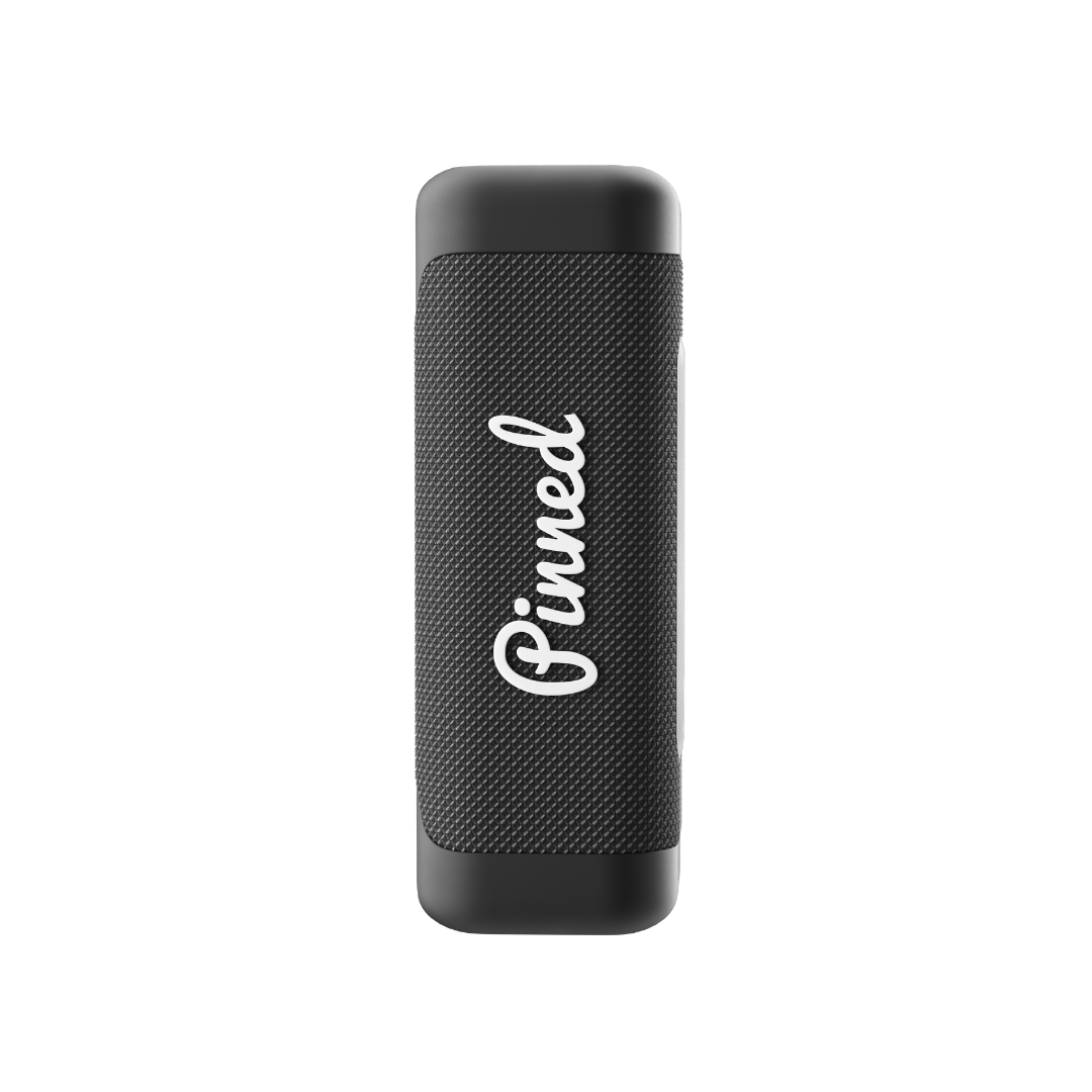 Black portable speaker with 'Pinned' branding in white on a white background