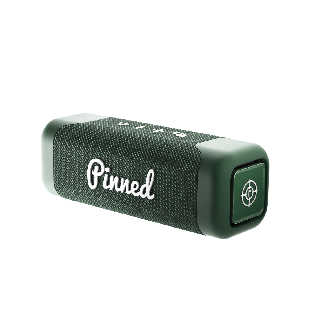 Green portable speaker with 'Pinned' branding in white on a white background