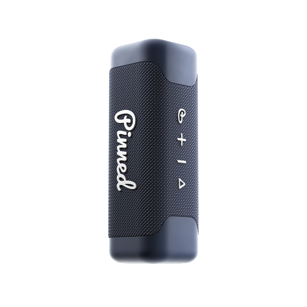 Navy blue portable speaker with 'Pinned' branding in white on a white background