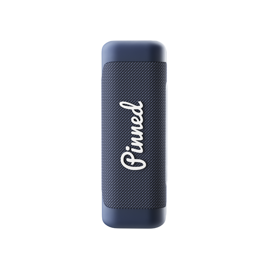 Navy blue portable speaker with 'Pinned' branding in white on a white background