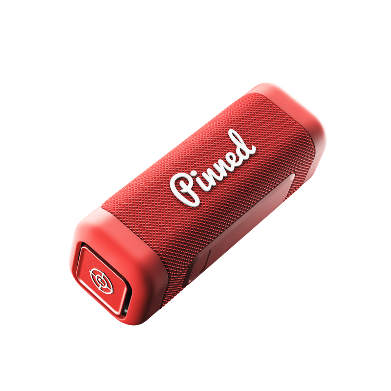 Red portable speaker with 'Pinned' branding in white on a white background