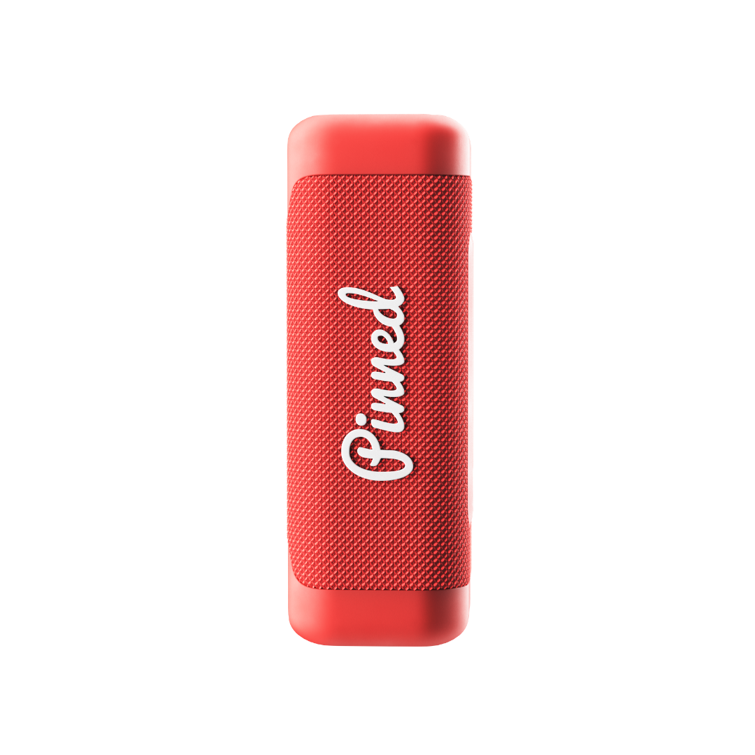Red portable speaker with 'Pinned' branding in white on a white background